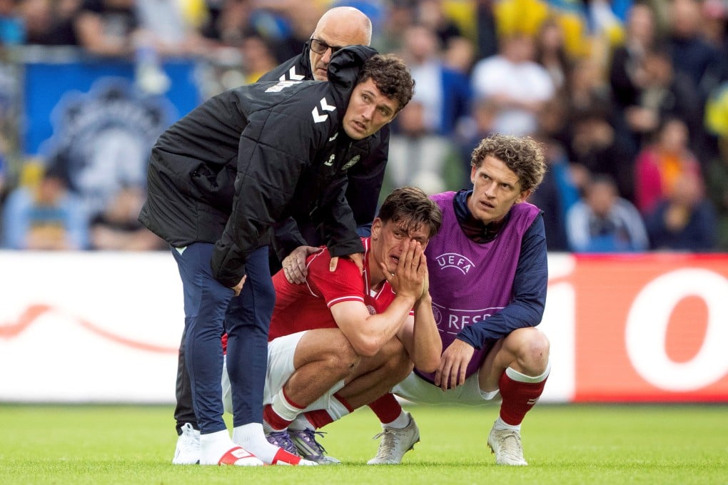 Denmark’s Joakim Maehle, Andreas Christensen and Jens Stage react after Christian Eriksen collapsed on the pitch in Odense, Denmark on Sunday. Photo: Ritzau Scanpix via Reuters