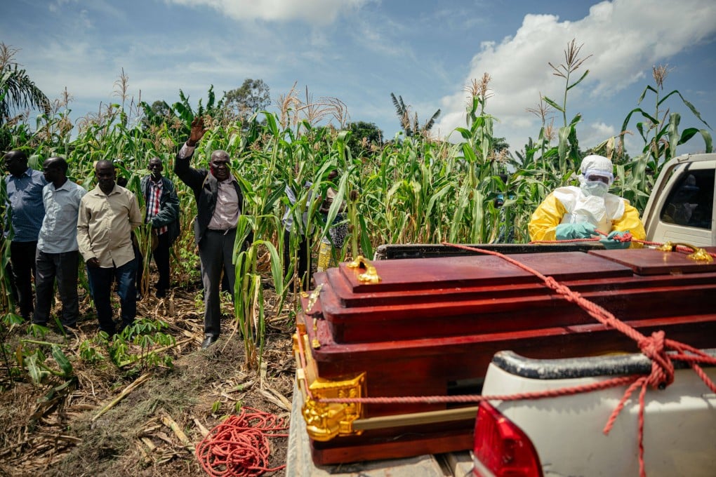 Members of a Congolese Red Cross team place the coffin of a woman suspected of having died from Ebola on a truck ahead of her burial at her home in Bunia. Photo: AFP