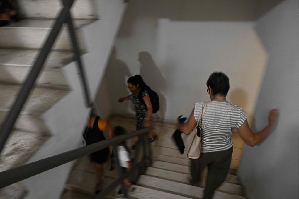 Workers rush down down a stairwell in Havana following a rare 6.1-magnitude earthquake that struck off the coast of Cuba on Monday. Photo: AFP