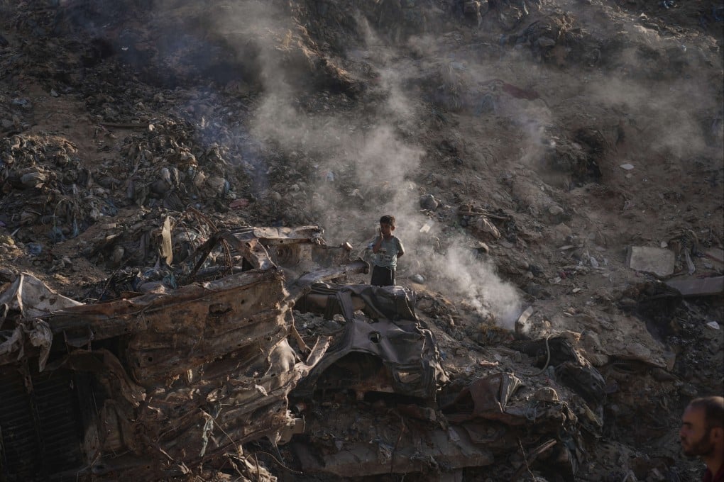 A child searches for plastic at a landfill in Gaza City on Monday. Photo: AP