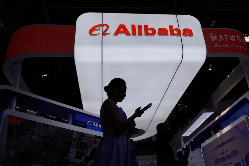 A visitor walks in front of the Alibaba booth during the third China International Supply Chain Expo at the China International Exhibition Center in Beijing in July 2025. Photo: AP