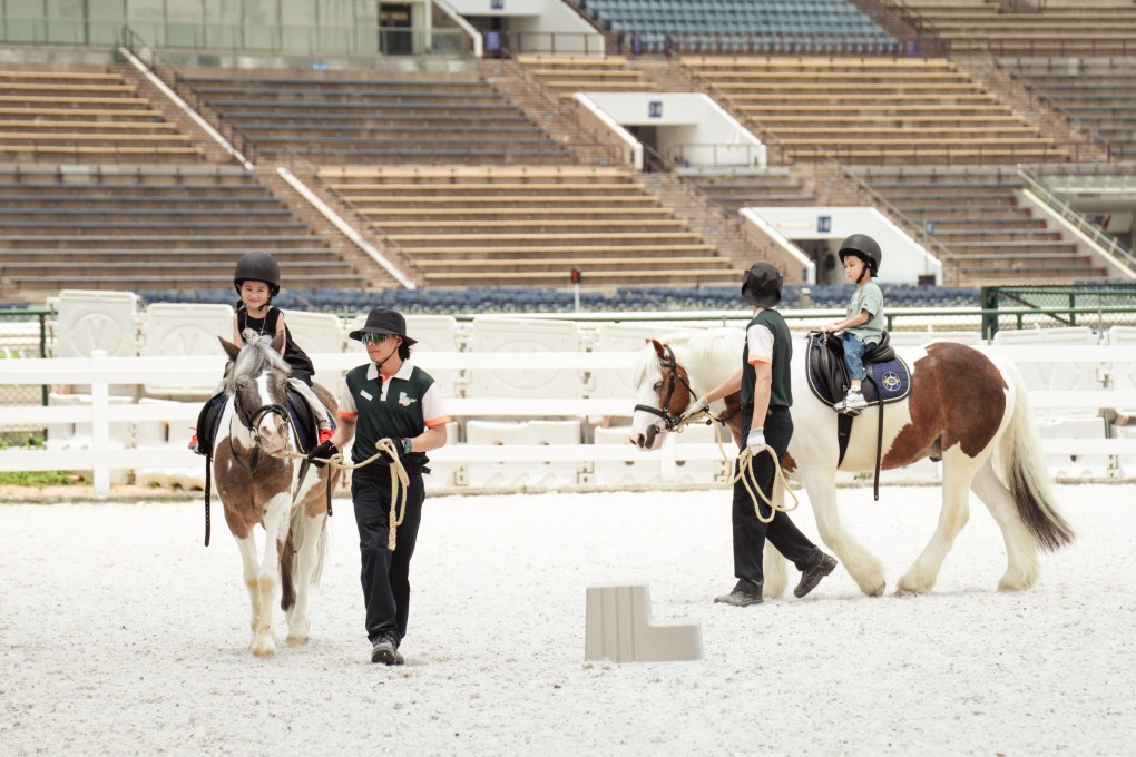 Children as young as three can ride ponies, guided by equestrian coaches, at Pony World. Photo: Alexander Mak