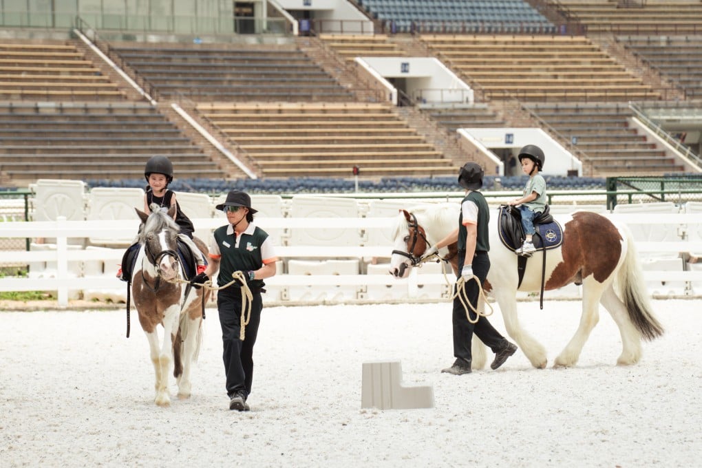 Children as young as three can ride ponies, guided by equestrian coaches, at Pony World. Photo: Alexander Mak