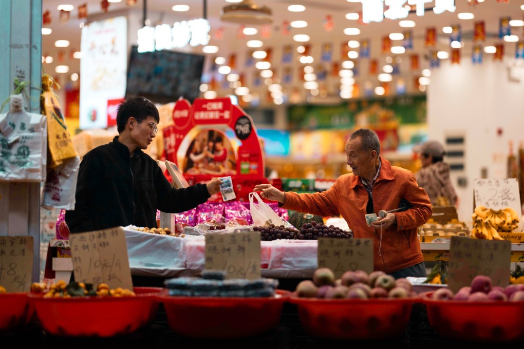 A man purchases groceries at a shop in Shanghai. Photo: EPA