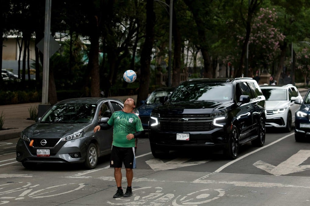A man plays football on the street in Mexico City. Photo: Getty Images