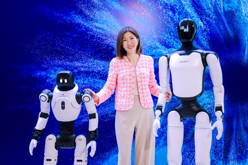 Bonnie Chan Yiting, CEO of Hong Kong Exchanges and Clearing, poses with humanoid robots at the bourse operator's    Future Tech Summit in Shenzhen on Thursday. Photo: Handout