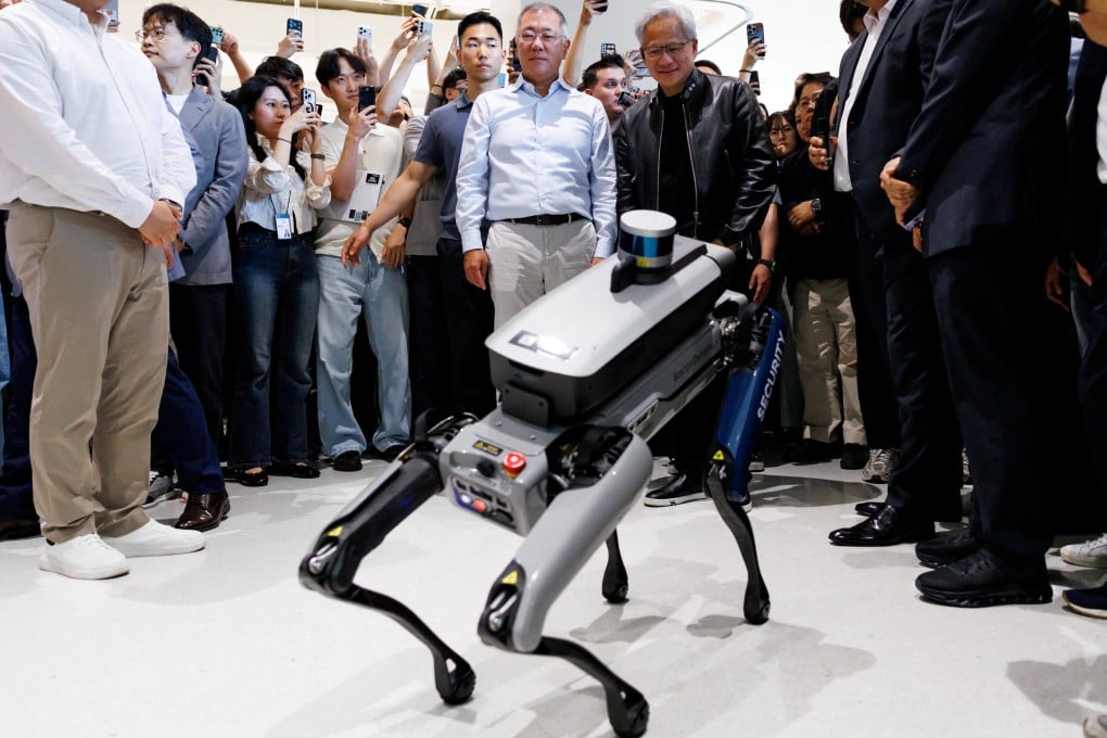 Nvidia CEO Jensen Huang (centre) looks at a Boston Dynamics Spot robot at the Hyundai Motor Group headquarters in Seoul on Monday. Photo: Reuters