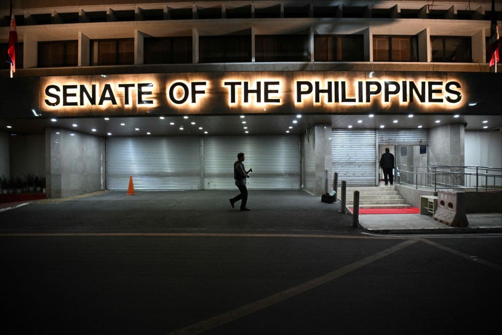 Armed Senate security personnel at the entrance of the Senate building in Manila on May 13 after gunshots were heard inside the Senate building. Photo: AFP