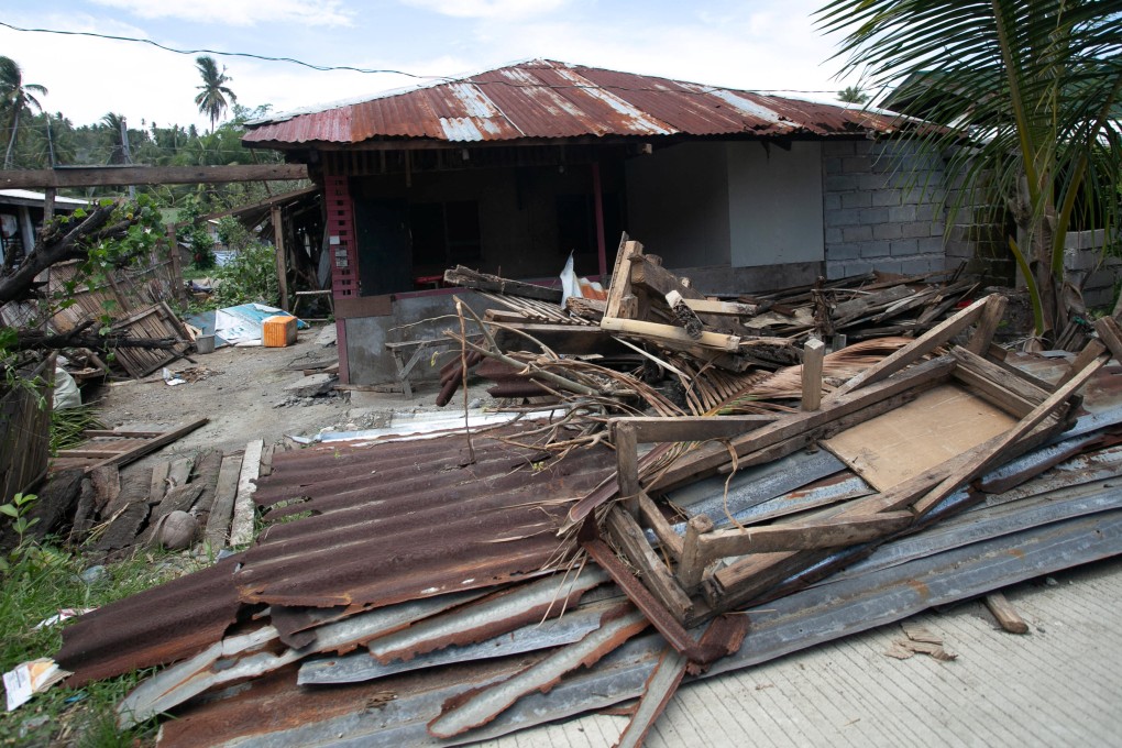 Debris from a damaged house in Glan is scattered along the road following Monday’s magnitude 7.8 quake. Photo: Reuters