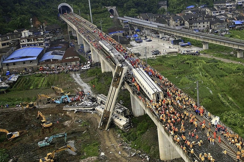 Chinese rescuers work around the wreckage of train cars in Wenzhou in east China’s Zhejiang province on Sunday, July 24, 2011, after a bullet train crashed into another high-speed train, killing 40 people. Photo: AP/Color China Photo/China Out