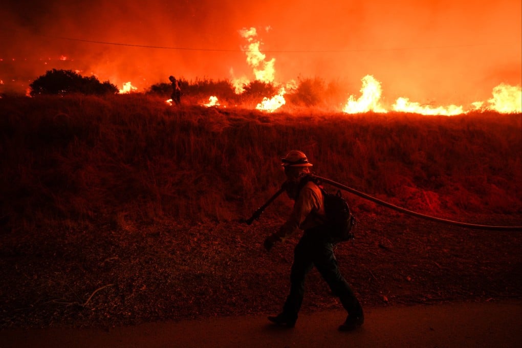 A firefighter monitors flames caused by the Hughes Fire in California, in January 2025. Scientists fear El Nino will exacerbate the heat of a planet already warming from burning fossil fuels. Photo: AP