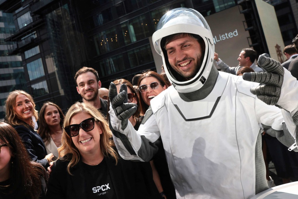 SpaceX employees celebrate the firm’s record-breaking IPO in New York on Friday. Photo: AFP