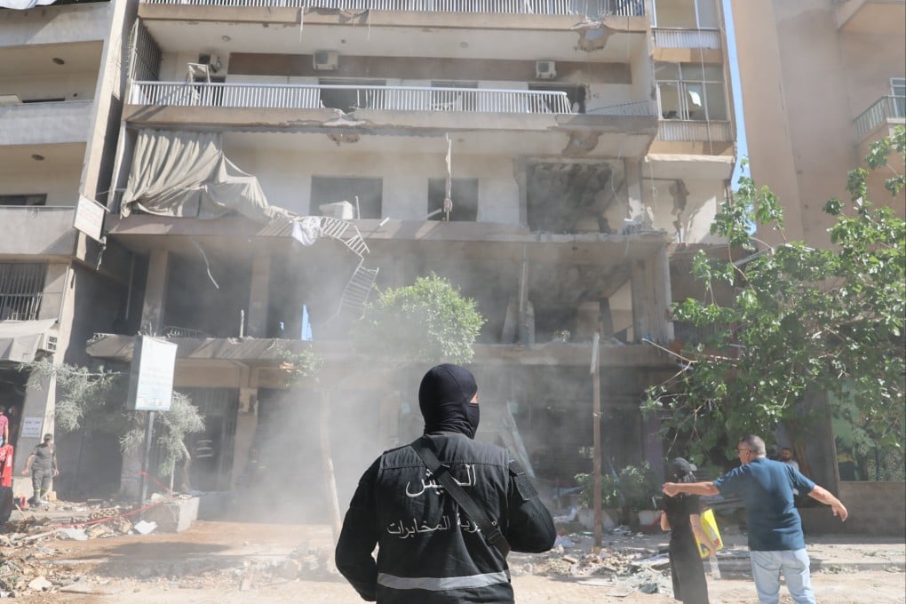 A Lebanese security serviceman stands near the site of a flat targeted by an Israeli airstrike in Beirut’s southern suburbs, Lebanon on Sunday. Photo: EPA