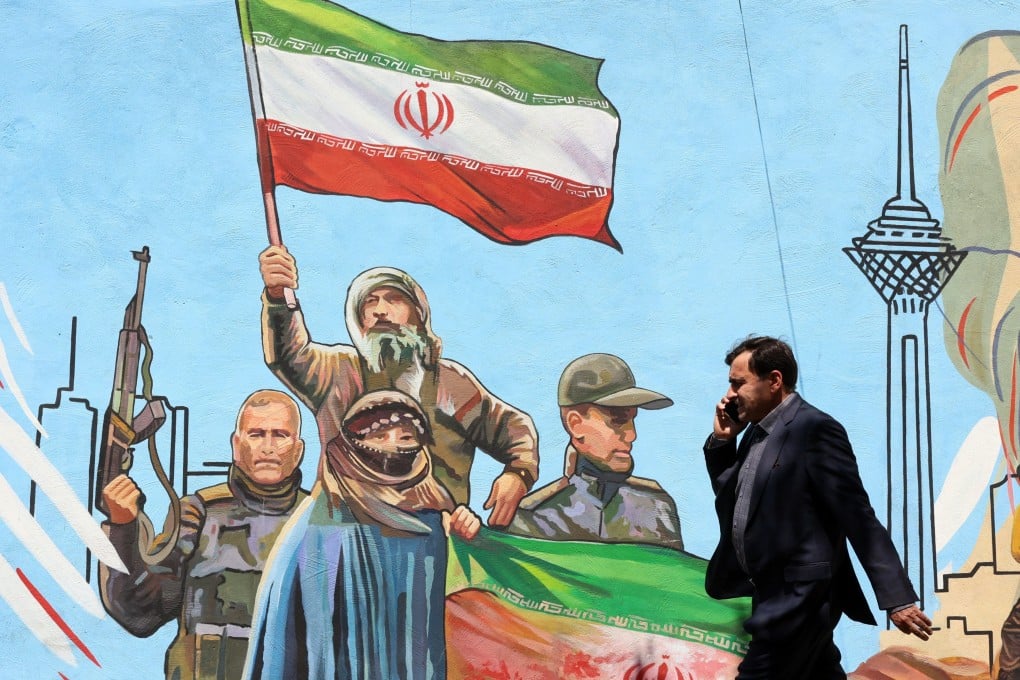An Iranian man walks past a mural on a street in Tehran, Iran, on June 8. Photo: EPA