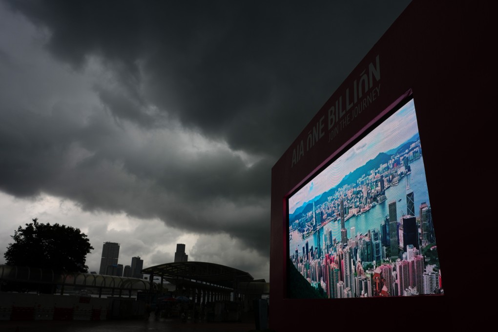 Thick clouds darken the sky at the Central Harbourfront as rain continues to lash the city. Photo: Sam Tsang