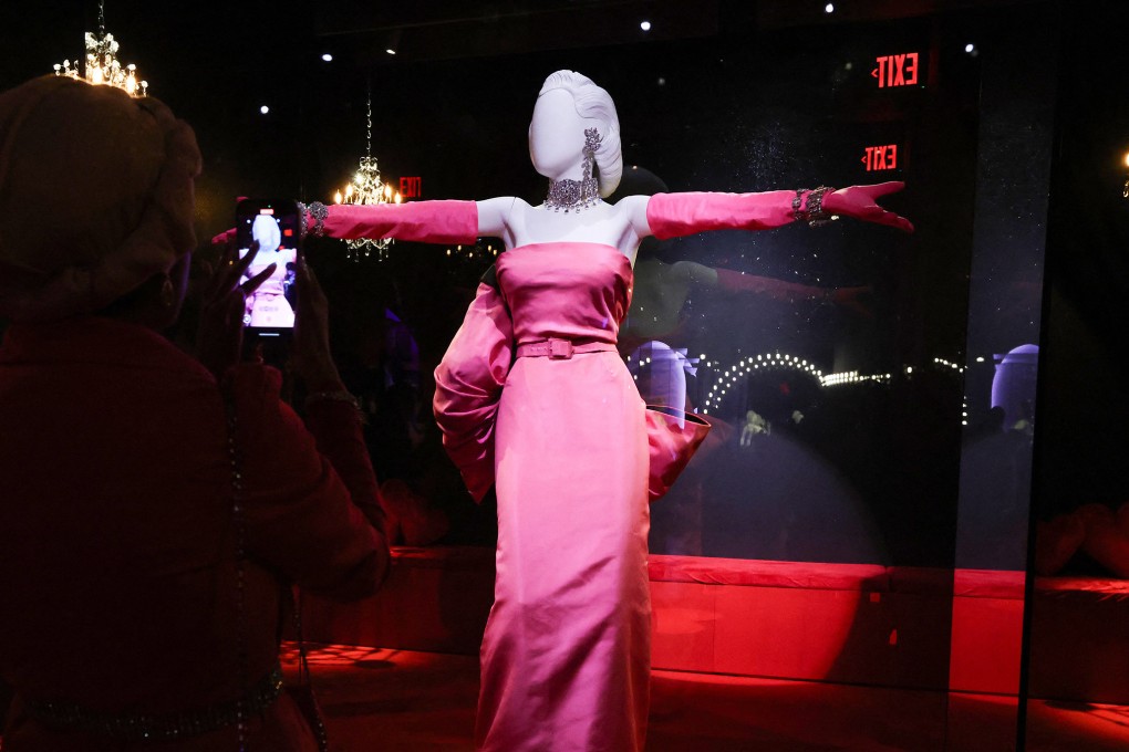 A guest photographs one of Marilyn Monroe’s iconic dress at an exhibition preview for “Marilyn Monroe: Hollywood Icon” at the Academy Museum of Motion Pictures in Los Angeles on May 27, 2026. Photo: AFP