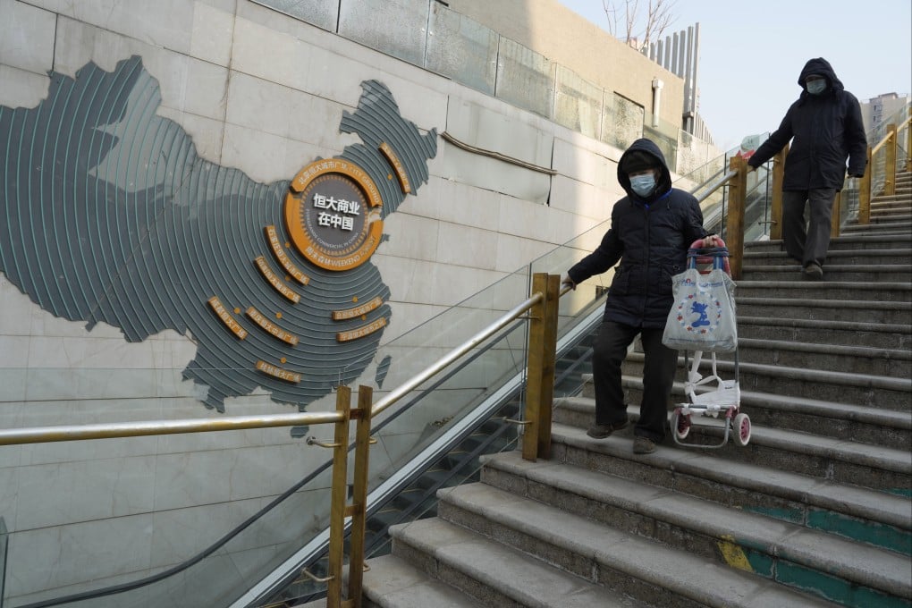 Residents walk through a partially shuttered China Evergrande commercial complex in Beijing on January 29, 2024 - the same day the firm was ordered to liquidate by a Hong Kong court. Photo: AP
