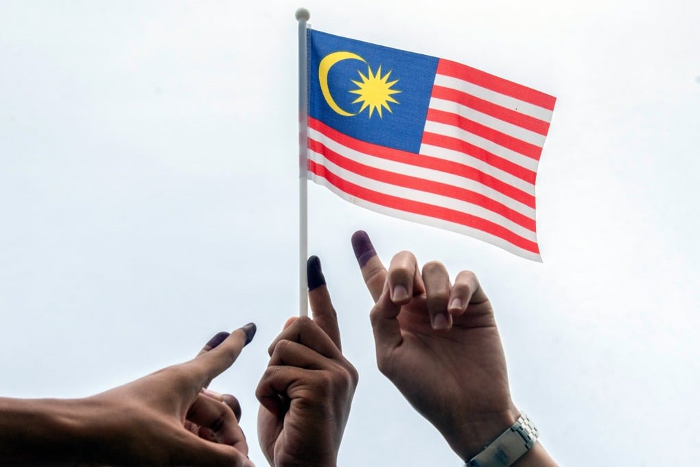 Malaysian voters show their fingers dipped in ink after voting in the last general election in 2022. Photo: Bernama/dpa