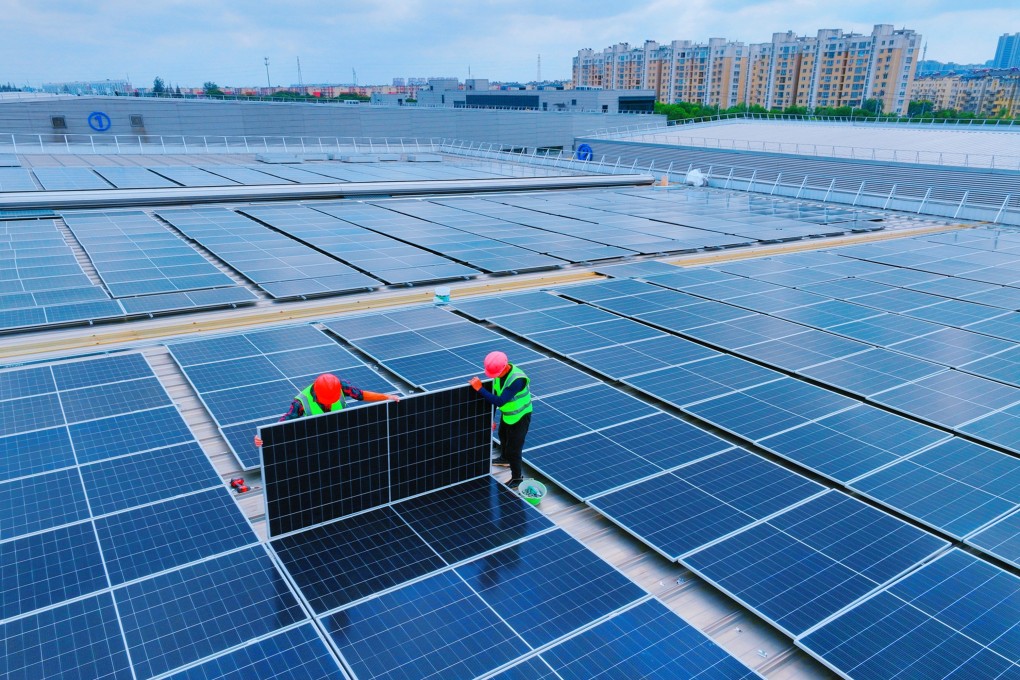 Workers install solar panels on the rooftop of a factory in Rugao, Jiangsu province, in October 2024. Photo: Wu Shujian/Feature China/Future Publishing via Getty Images