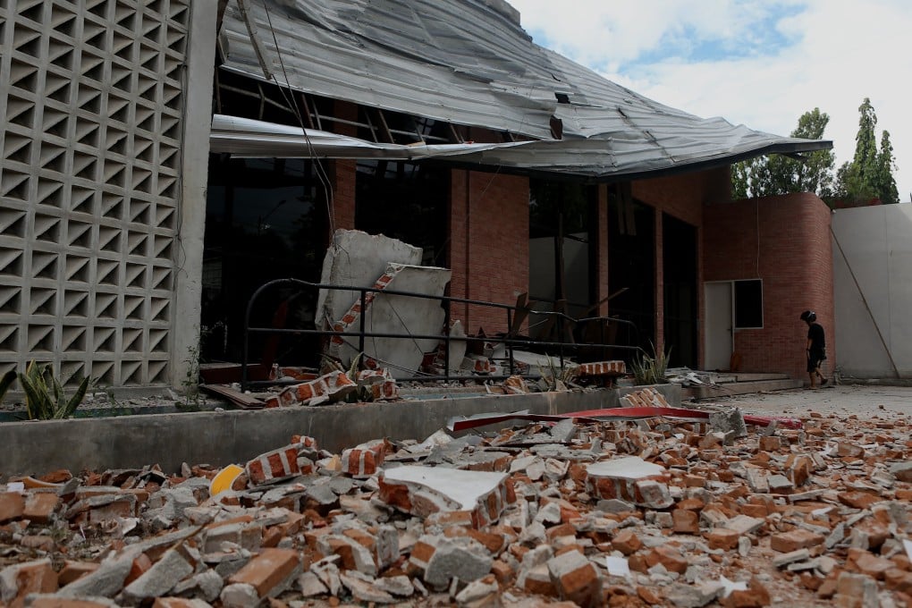 A man inspects a damaged building following an earthquake in Palu, Central Sulawesi, on Tuesday. Photo: EPA