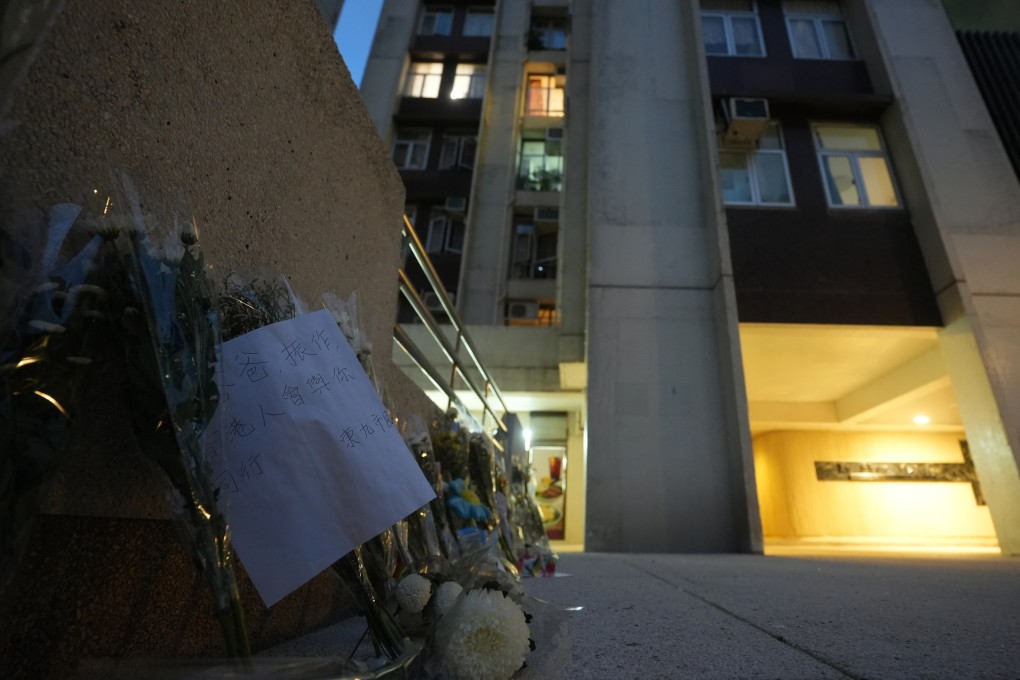 Flowers are left outside Lu Shan Mansion, Taikoo Shing, where a 48-year-old mother and 12-year-old daughter fell from same flat hours apart last week. Photo: Sun Yeung