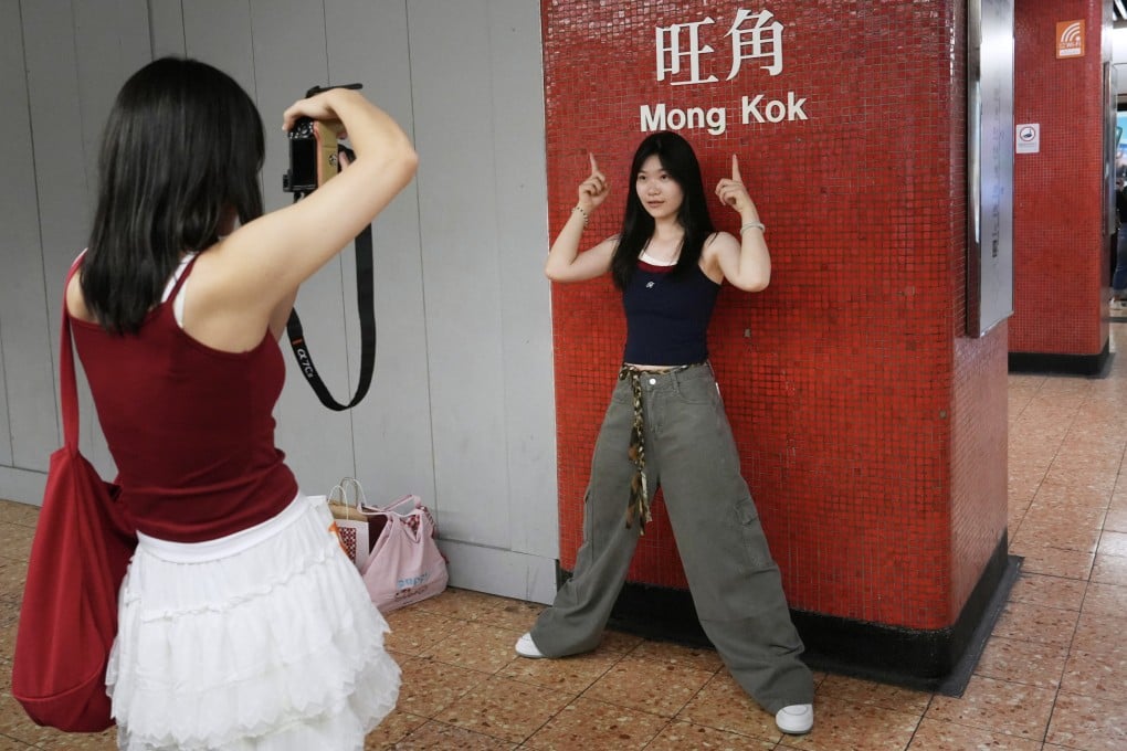Tourists take photos at the Mong Kok MTR Station on October 6, 2025. Photo: Sun Yeung