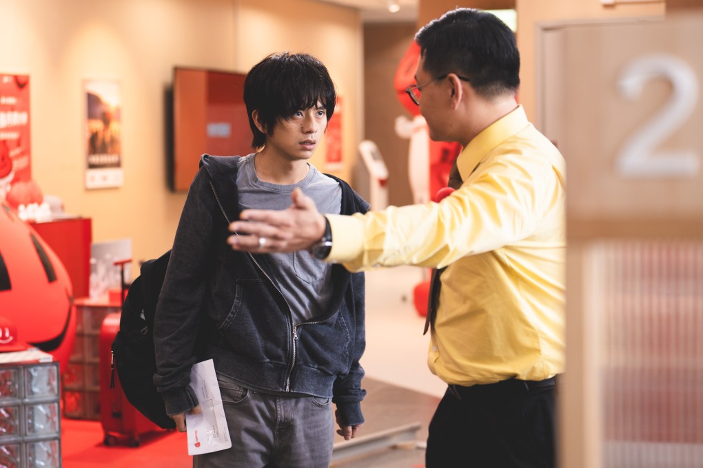Yukki Tai as the frustrated Tak (left) and Michael Ning as desk agent Ringo in a still from Dog Day Evening.