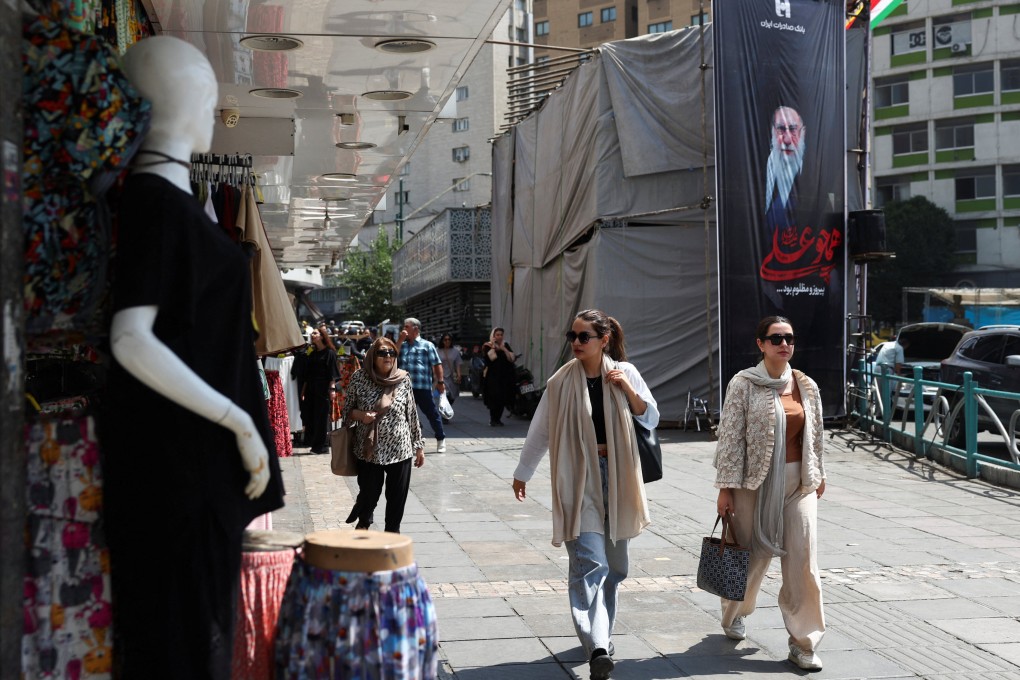 People walk past a banner with a picture of Iran’s late Supreme Leader Ayatollah Ali Khamenei in Tehran on Wednesday. Photo: WANA/Reuters