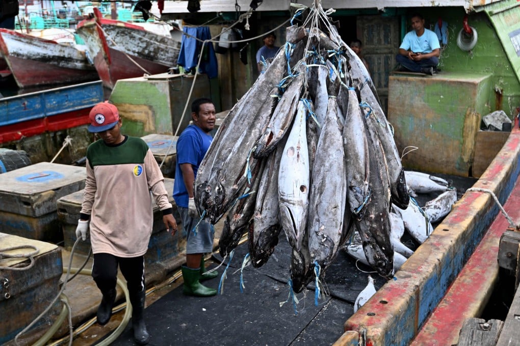 Workers load flash-frozen fish onto a truck from a longline vessel at the Benoa fishing port near Denpasar, on Indonesia’s Bali island, on March 16, 2025. Photo: AFP