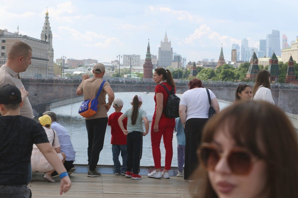 People take in the sights outside the Kremlin in downtown Moscow on June 5. Photo: EPA