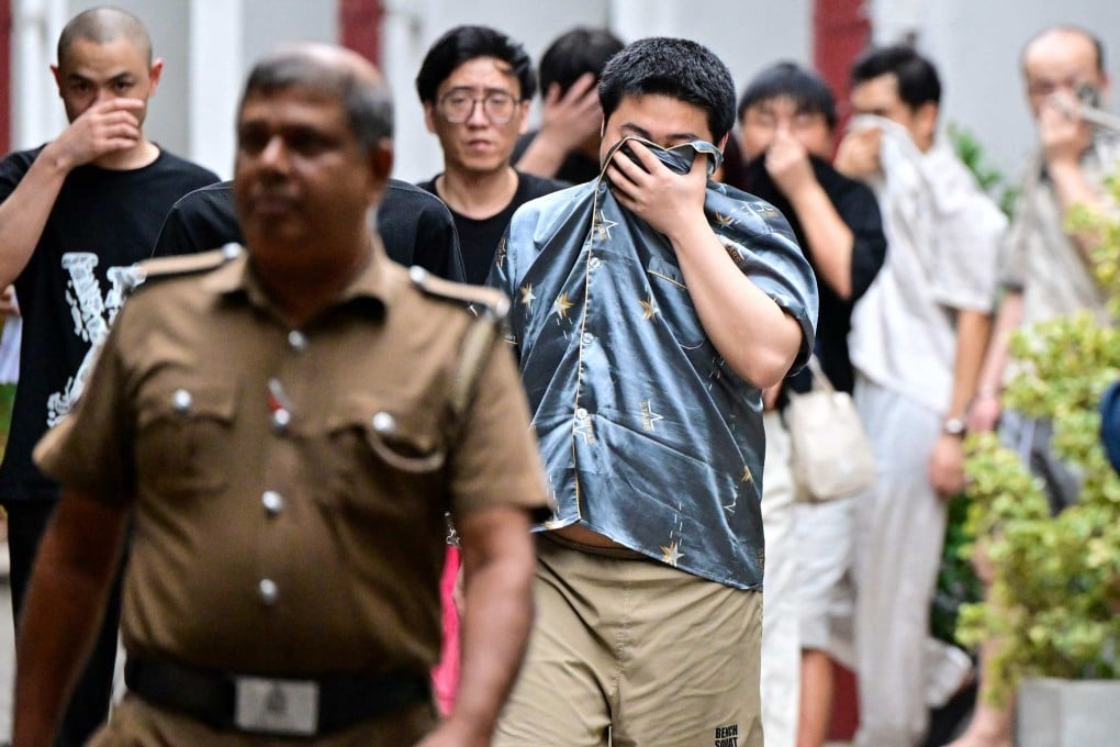 Chinese nationals suspected of running cyberscam centres are escorted to a prison after their arrest in Colombo on May 9. Photo: AFP