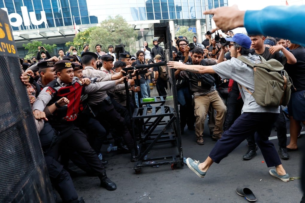 Students clash with police officers during a protest against a fuel price hike in Jakarta on June 12. Photo: EPA