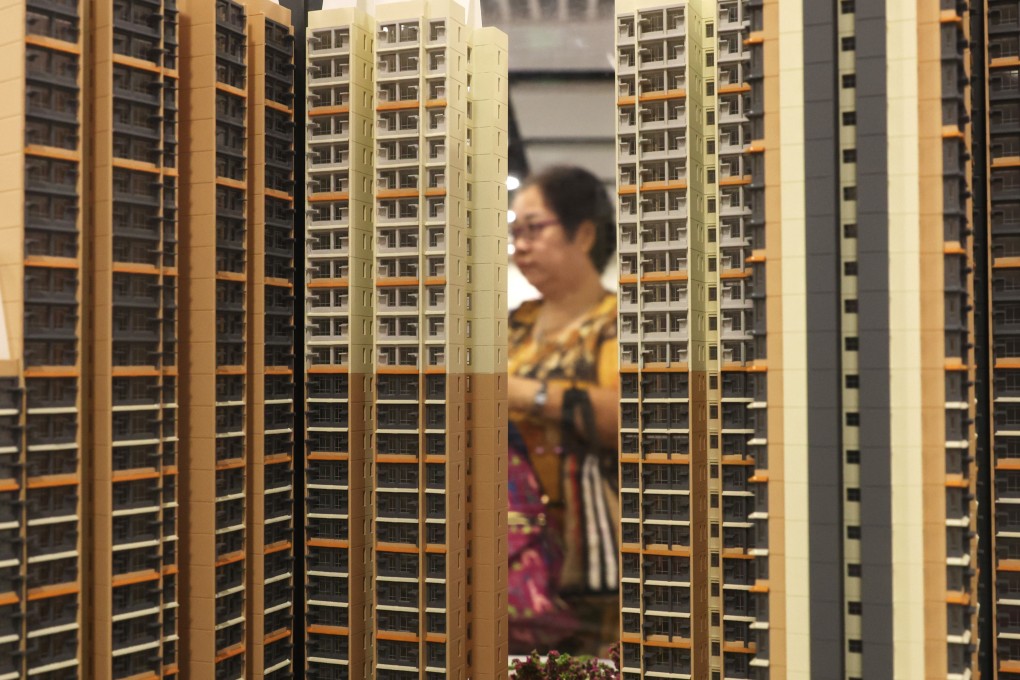 A potential homebuyer looks at a scale model of a subsidised housing estate. Photo: Yik Yeung-man