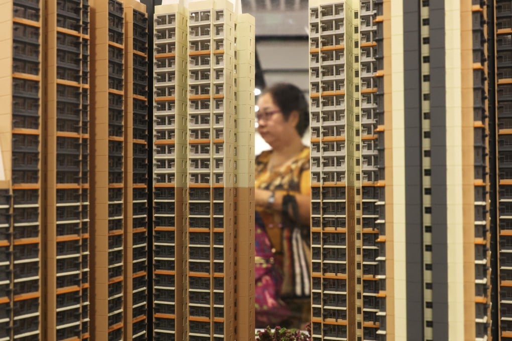 A potential homebuyer looks at a scale model of a subsidised housing estate. Photo: Yik Yeung-man