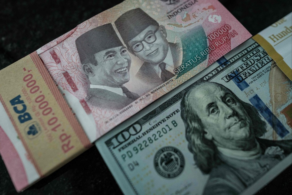Indonesian rupiah banknotes are pictured next to those of the US dollar at a currency exchange office in Jakarta on June 4. Photo: AFP