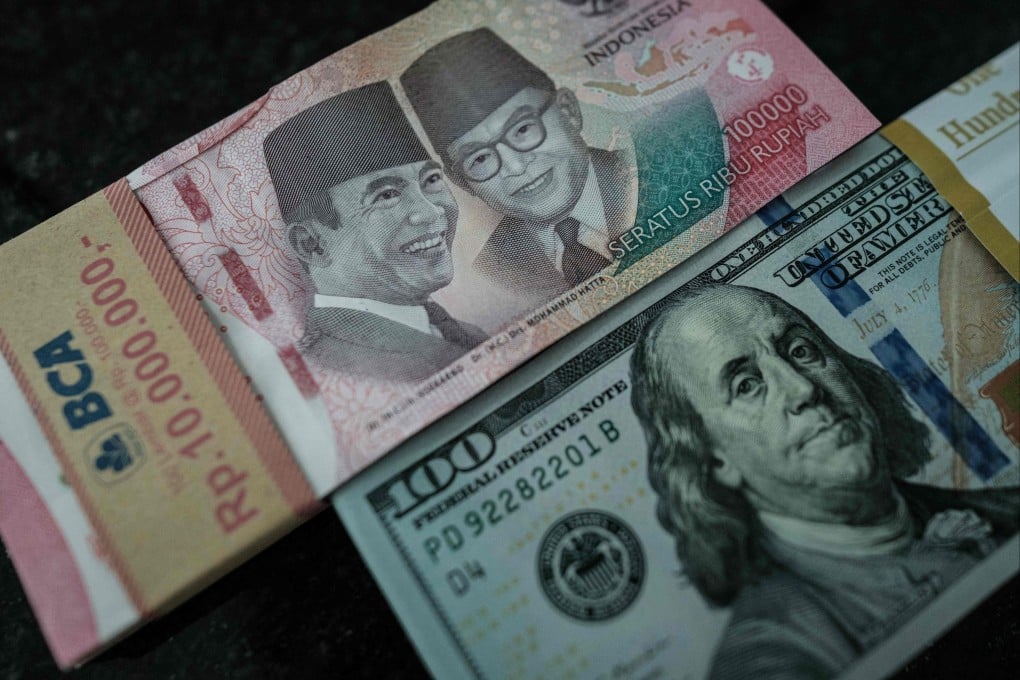 Indonesian rupiah banknotes are pictured next to those of the US dollar at a currency exchange office in Jakarta on June 4. Photo: AFP