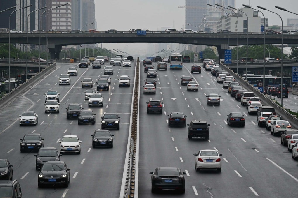 Cars drive along a highway in Beijing. Photo: AFP