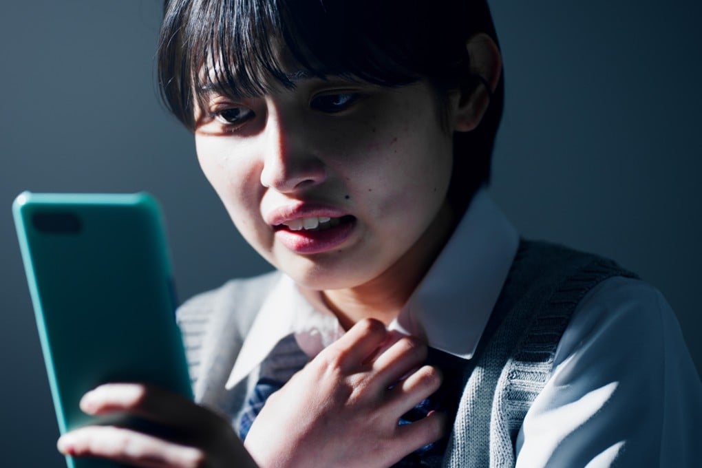 A Japanese high school student checks her smartphone. A Cabinet Office study released on May 1 reveals that more than half of teenage girls in Japan had used AI asked for advice on personal problems. Photo: Shutterstock
