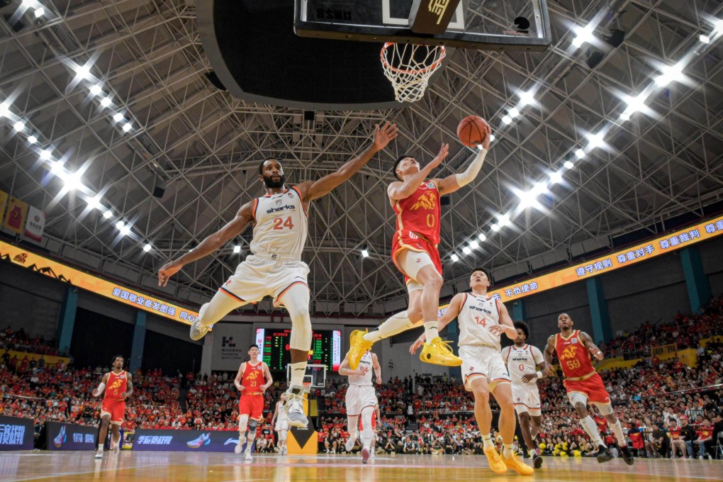 Lin Bingsheng (right) of Zhejiang Lions goes for a lay-up against Shanghai Sharks in the finals of the CBA 2025-2026 season, won by the Sharks. Photo: Xinhua