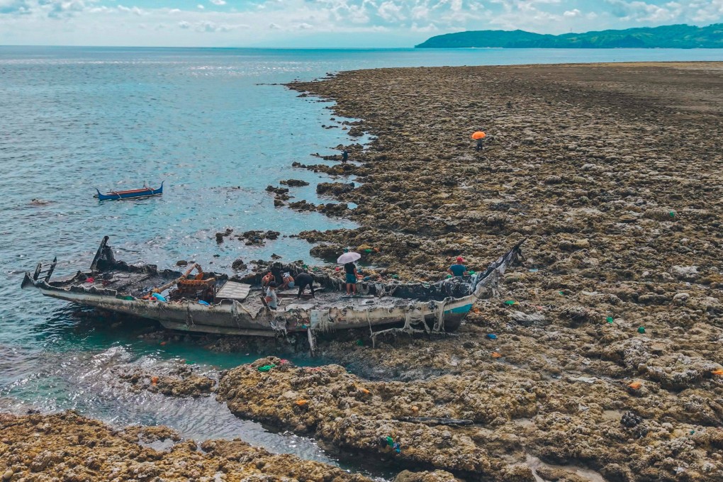 A fishing boat is stranded after the seabed is thrust upwards by the June 8 earthquake in the Philippines. Photo: AFP