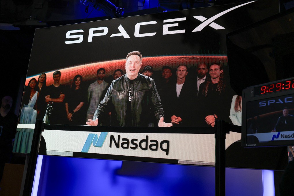 SpaceX CEO Elon Musk, displayed on a screen remotely from SpaceX headquarters in Starbase, Texas, speaks before the launch of SpaceX’s IPO at the Nasdaq MarketSite in New York City on June 12. Photo: AFP / Getty Images / TNS