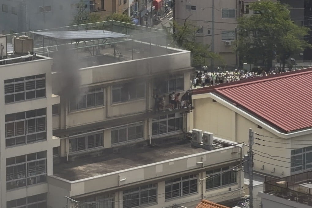 Smoke rises as students are evacuated from a primary school after a fire broke out in Kita city, Tokyo, on Friday. Photo: X/takanyo via Reuters