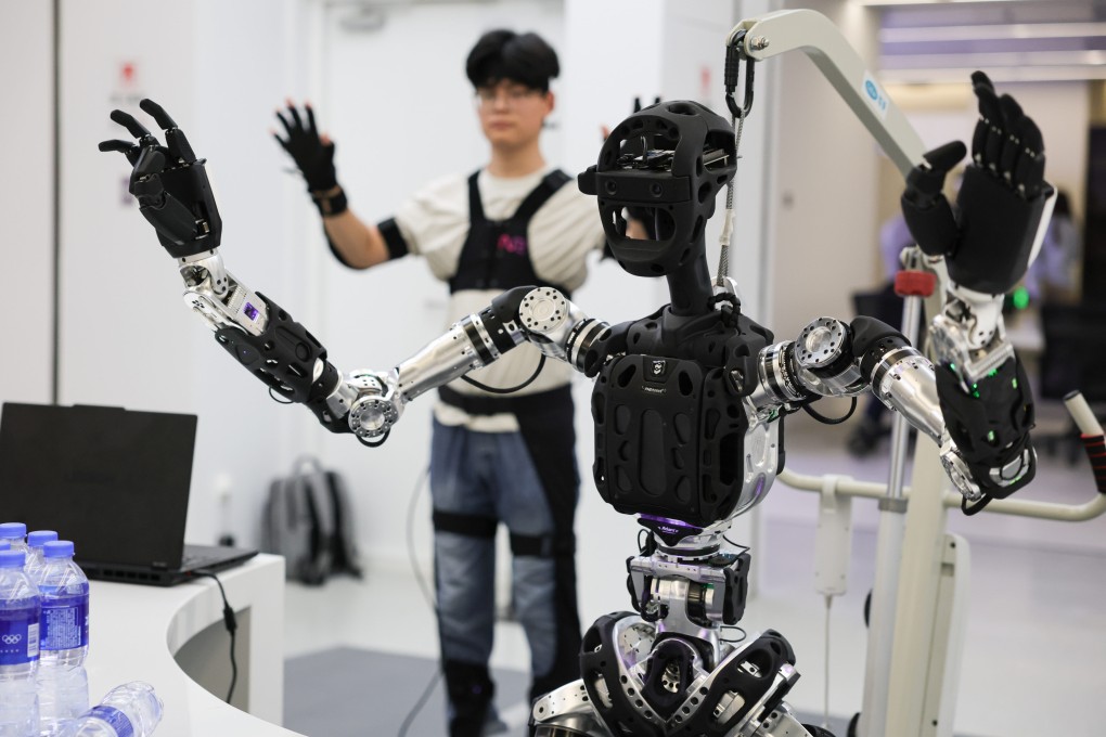 A staff member demonstrates the tele-operation of a robot at an embodied intelligence innovation industrial estate in Zhongguancun, in Beijing’s Haidian district. on Saturday. Photo: Xinhua