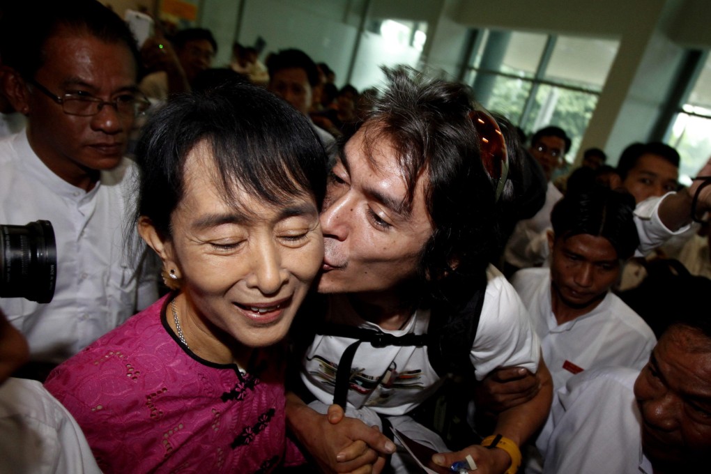 Aung San Suu Kyi receives a birthday kiss from her son Kim Aris upon his arrival at Yangon International Airport, Myanmar, on June 19, 2011. Photo: EPA