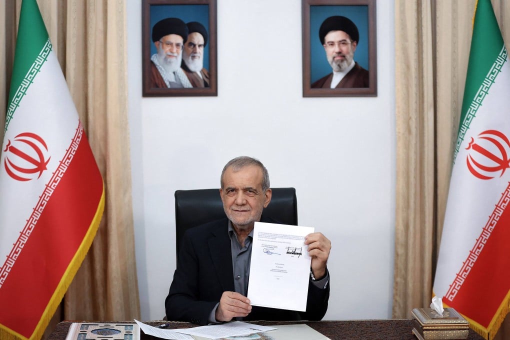 Iran’s President Masoud Pezeshkian holds a memorandum of understanding document showing his signature and that of US president Donald Trump, in Tehran on Wednesday. Photo: AFP