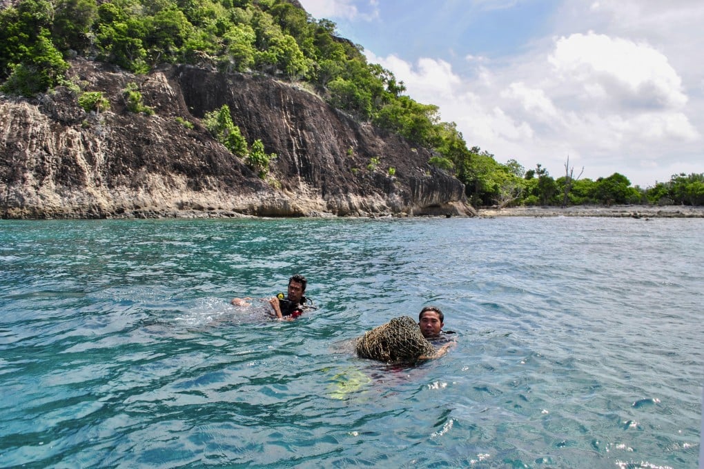 Divers retrieve an abandoned fishing net in Bawah Reserve, Indonesia’s Anambas Islands. Photo: Carolyn Beasley