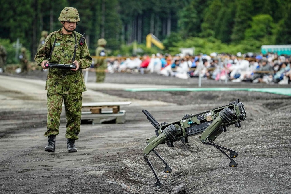 A Japan Ground Self-Defence Force soldier operates a quadrupedal uncrewed ground vehicle during a live-fire exercise in Gotemba on June 7. Photo: AFP