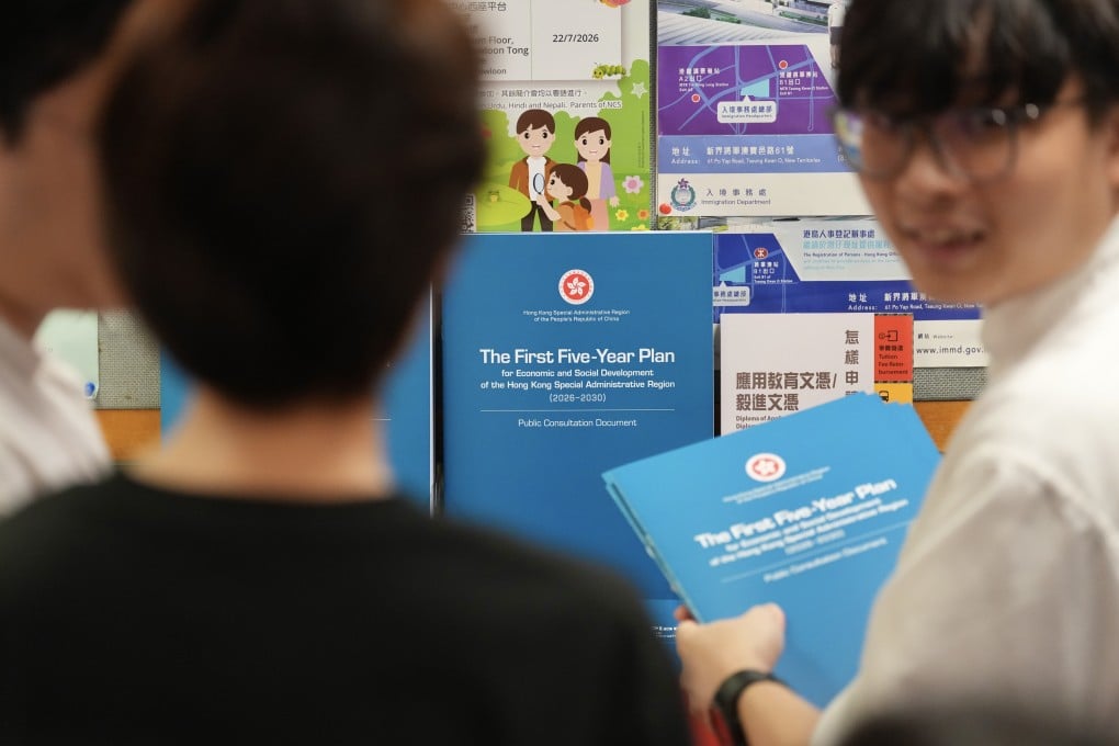 People collect copies of the consultation document for Hong Kong’s first five-year blueprint from the Wan Chai District Office on June 15. Photo: Karma Lo