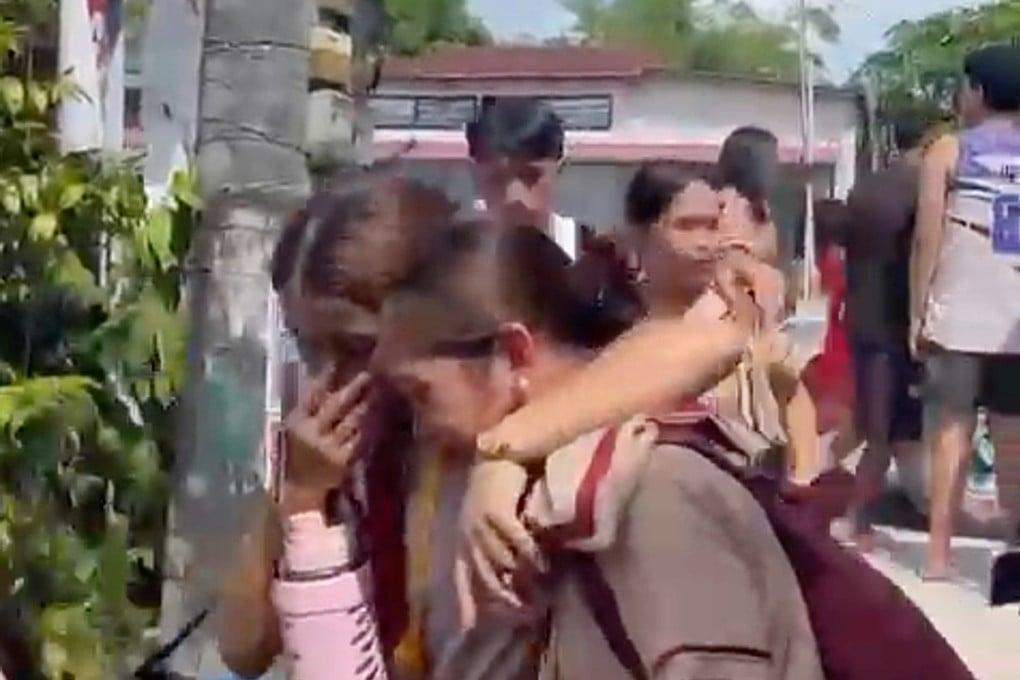 Students react after a fatal shooting at the San Jose National High School in Tacloban city in the Philippines on Monday. Photo: Video footage via AP