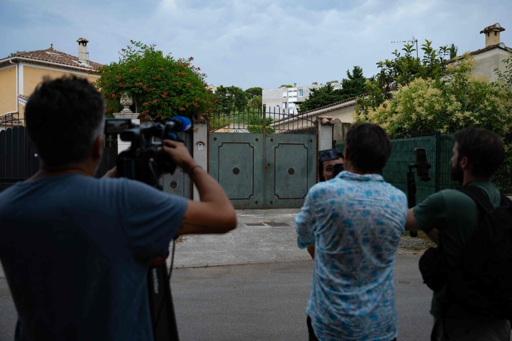 Journalists at the entrance of a residential pavillion where two children were found dead in their family car amid a heatwave, in Carpentras, southern France on Monday. Photo: AFP